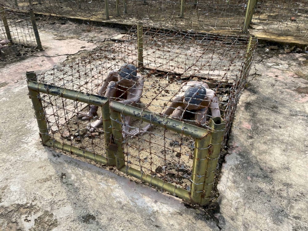 Inside the tiger cages, prisoners were forced to crouch or kneel to prevent injury from the sharp metal surrounding